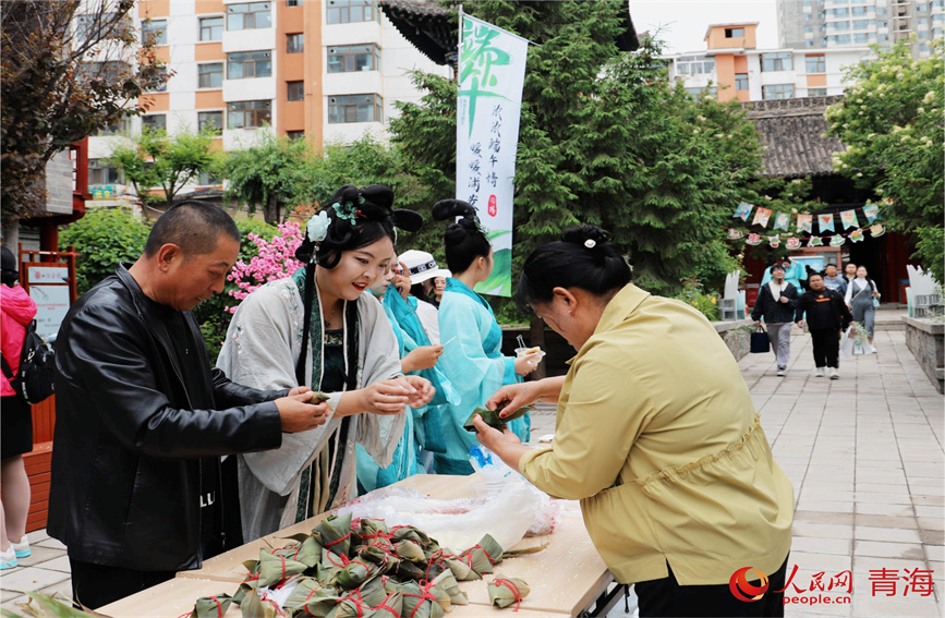 市民學(xué)習(xí)包粽子。人民網(wǎng) 顧斐菲攝